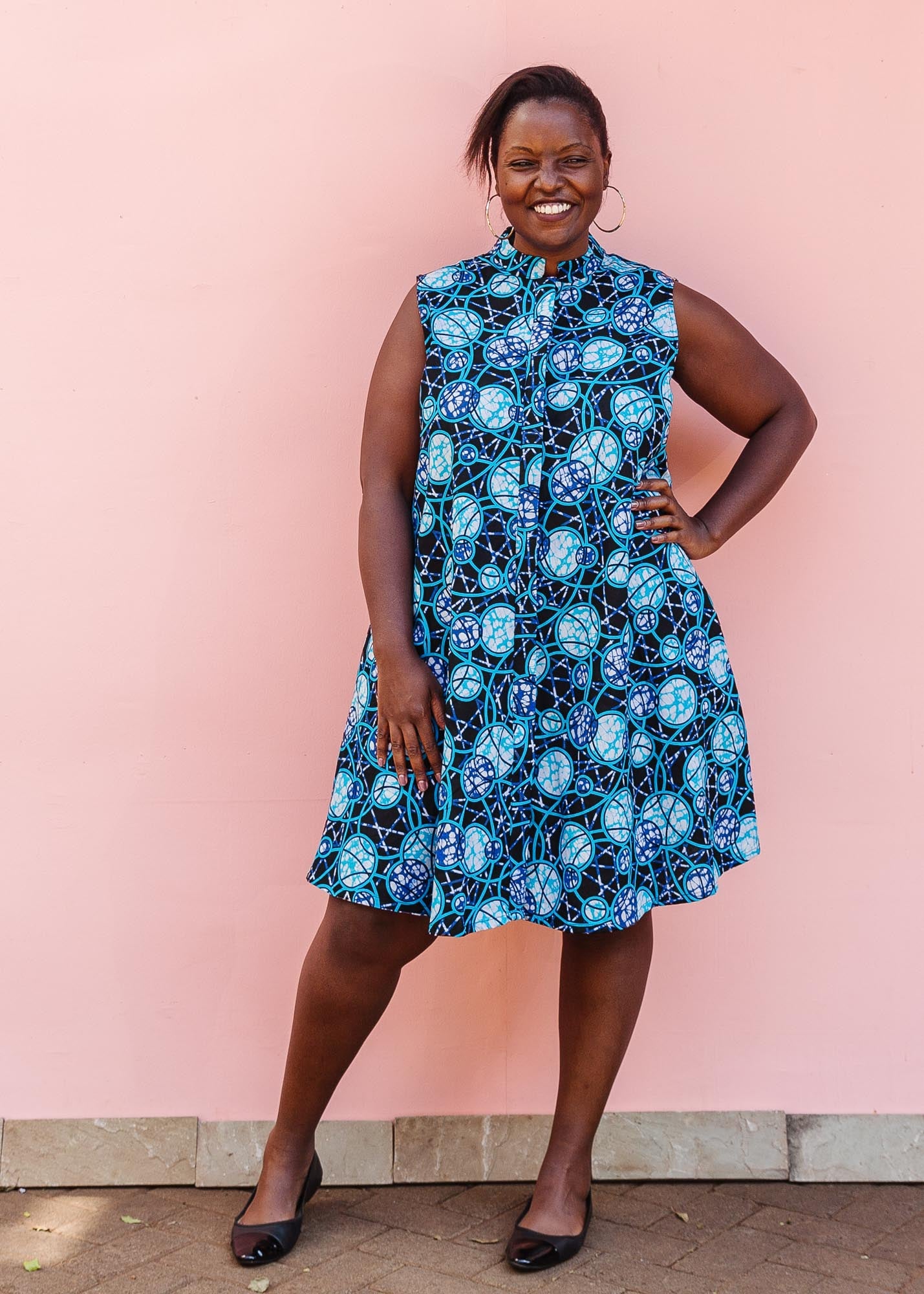 The model is wearing black dress with blue white and aqua colored full moon