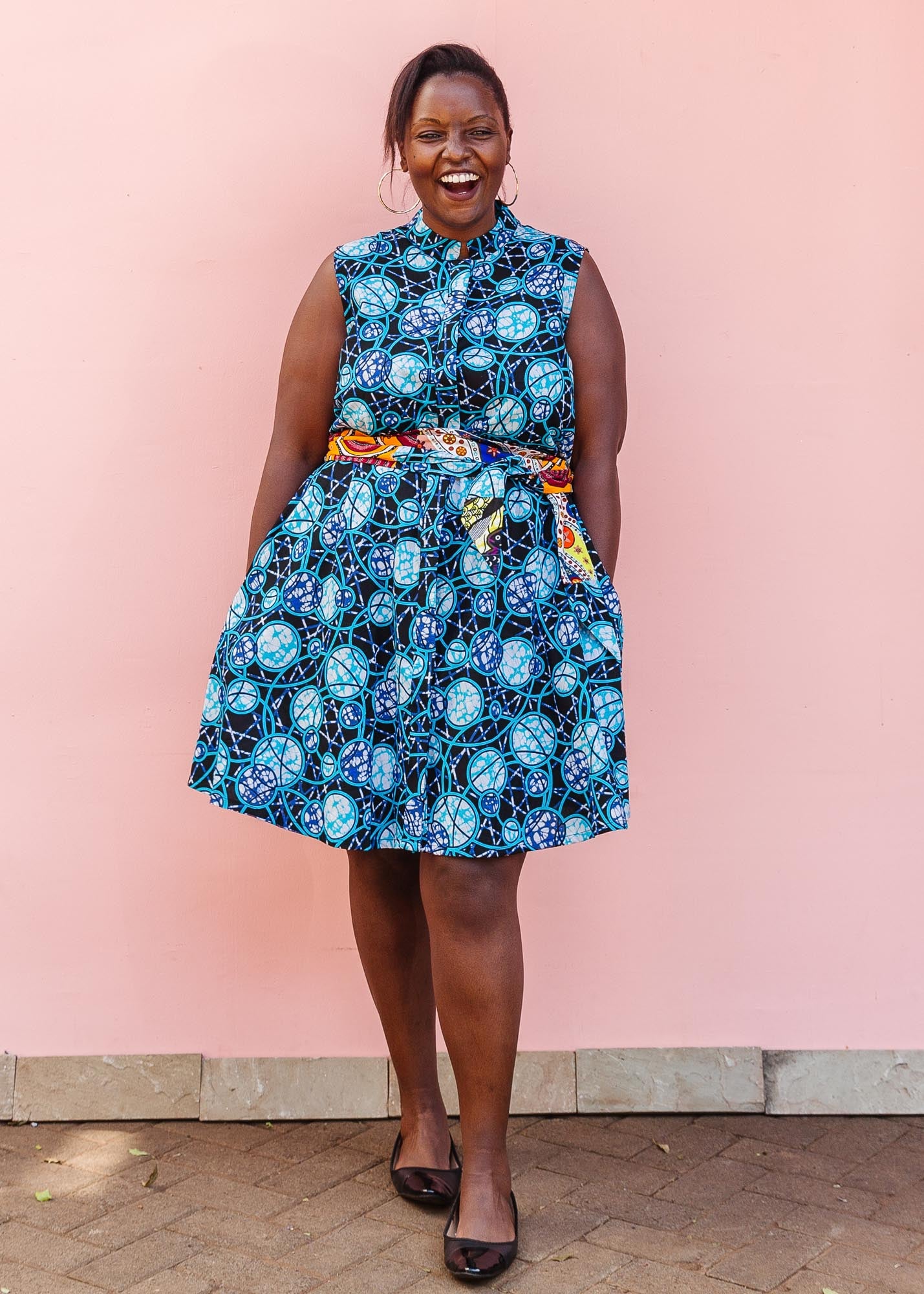 The model is wearing black dress with blue white and aqua colored full moon