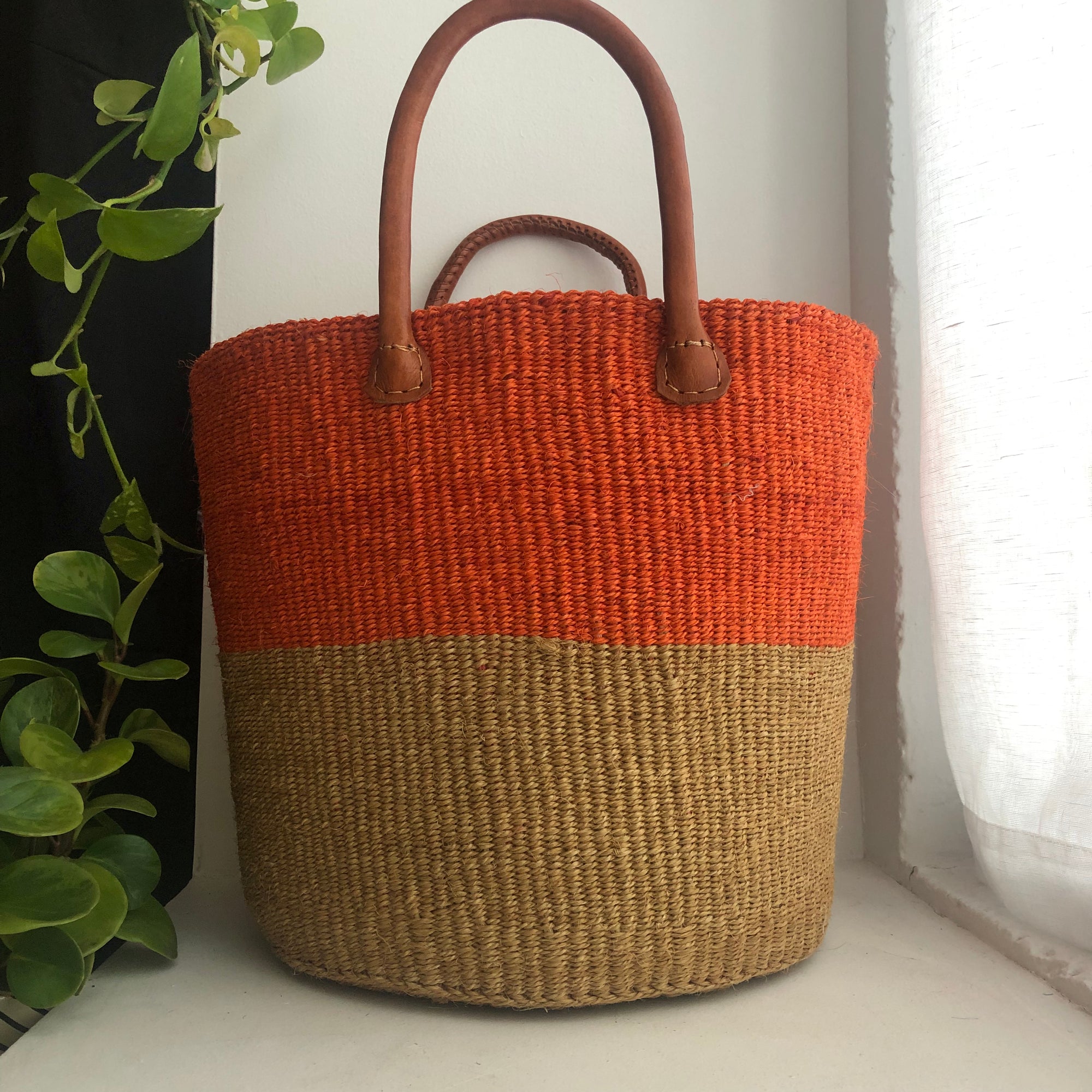 Orange basket with leather handles