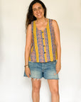 The model is wearing olive-yellow, blue, orange and white geometric printed  tank