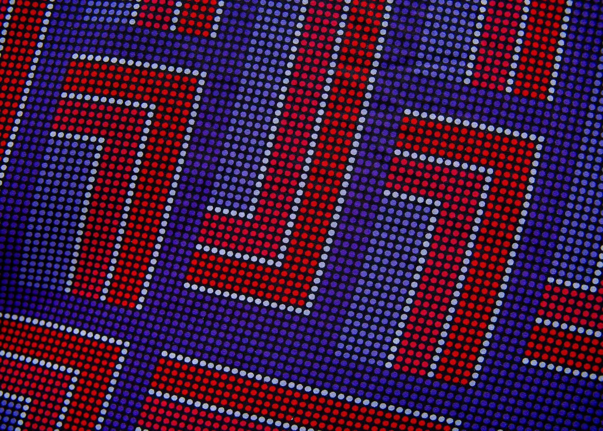 detail of a blue, red and lavender geometric shirt dress