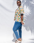 The model is wearing blue, orange, green, brown, white and black print shirt