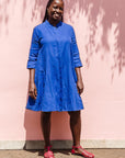 The model is wearing blue dress