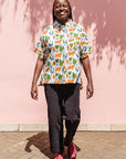 The model is wearing blue, orange, green, brown, white and black print shirt