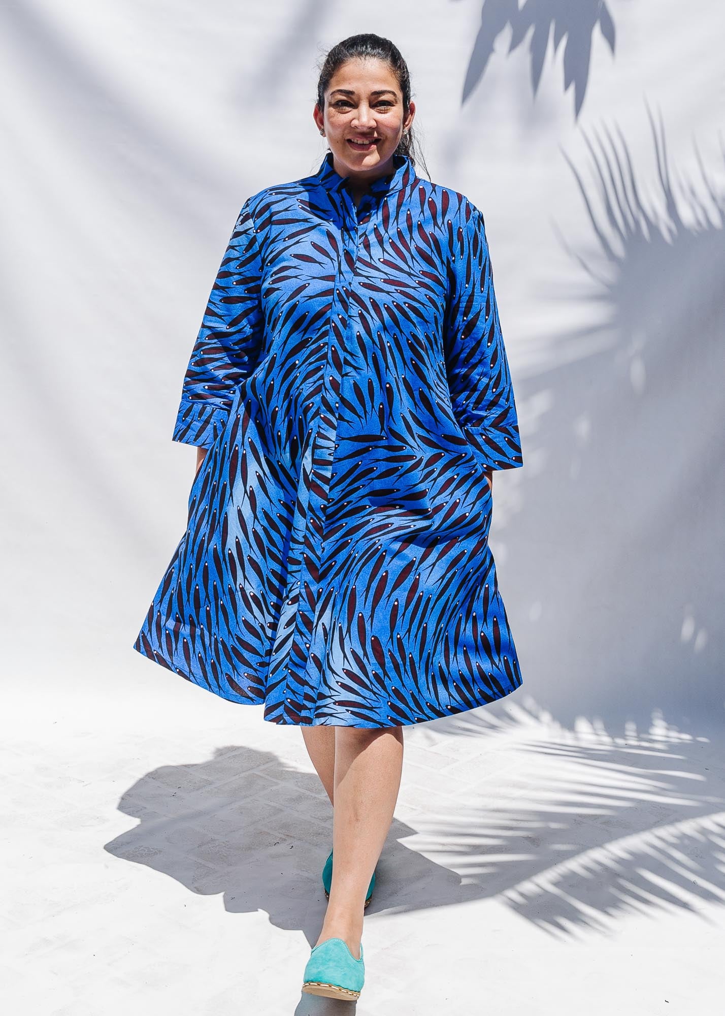 The model is wearing dark-red, blue and white baby shark printed dress