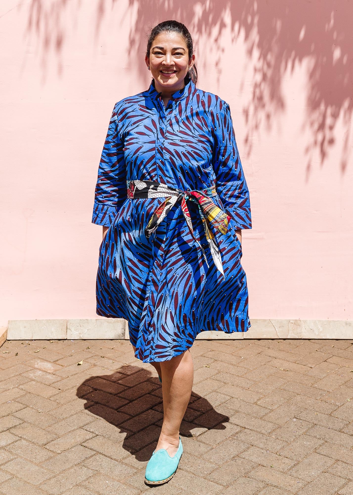 The model is wearing dark-red, blue and white baby shark printed dress