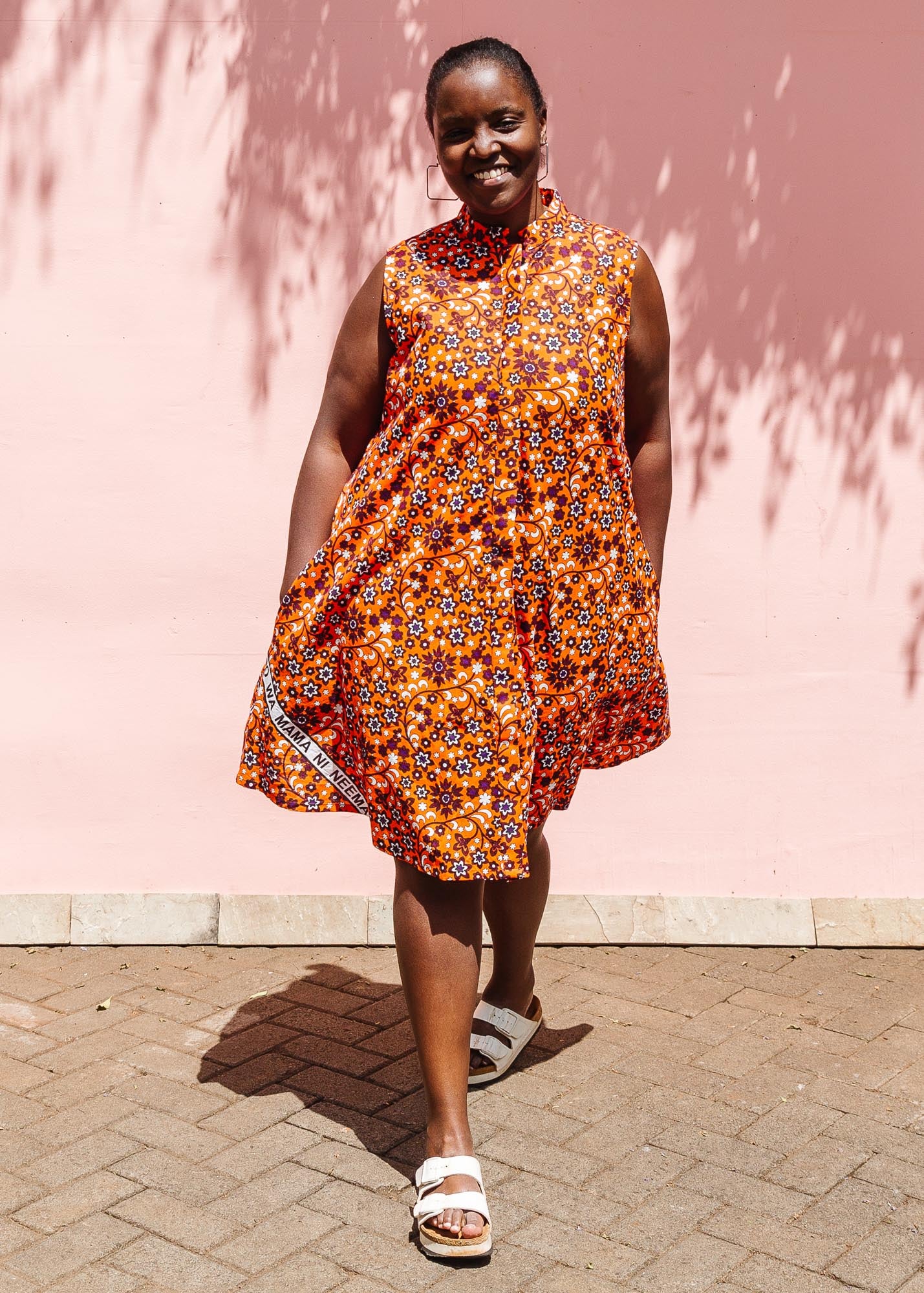 The model is wearing multi-colored floral print dress