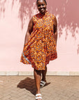 The model is wearing multi-colored floral print dress