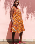 The model is wearing multi-colored floral print dress