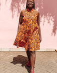 The model is wearing multi-colored floral print dress