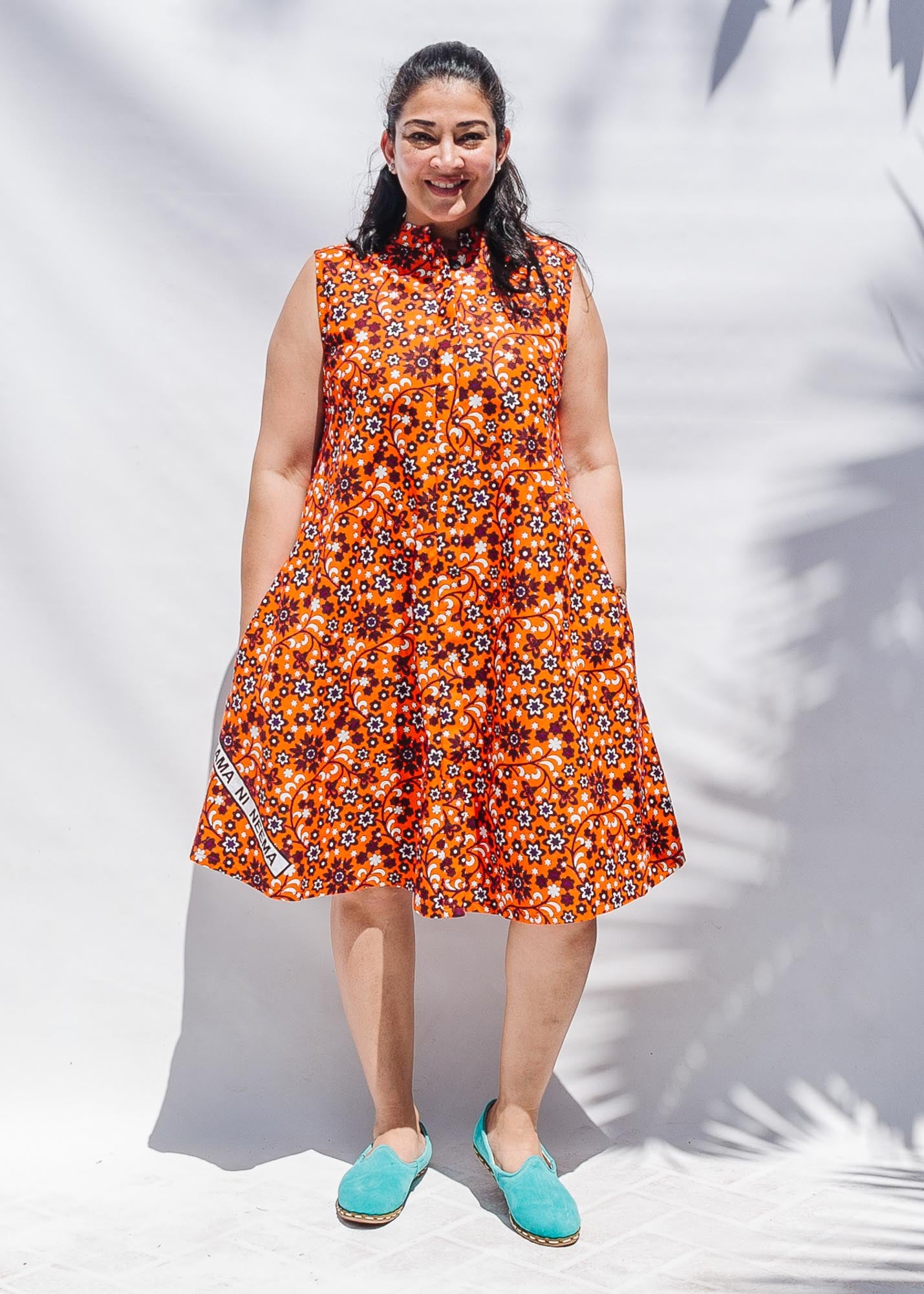 The model is wearing multi-colored floral print dress