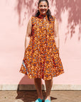 The model is wearing multi-colored floral print dress