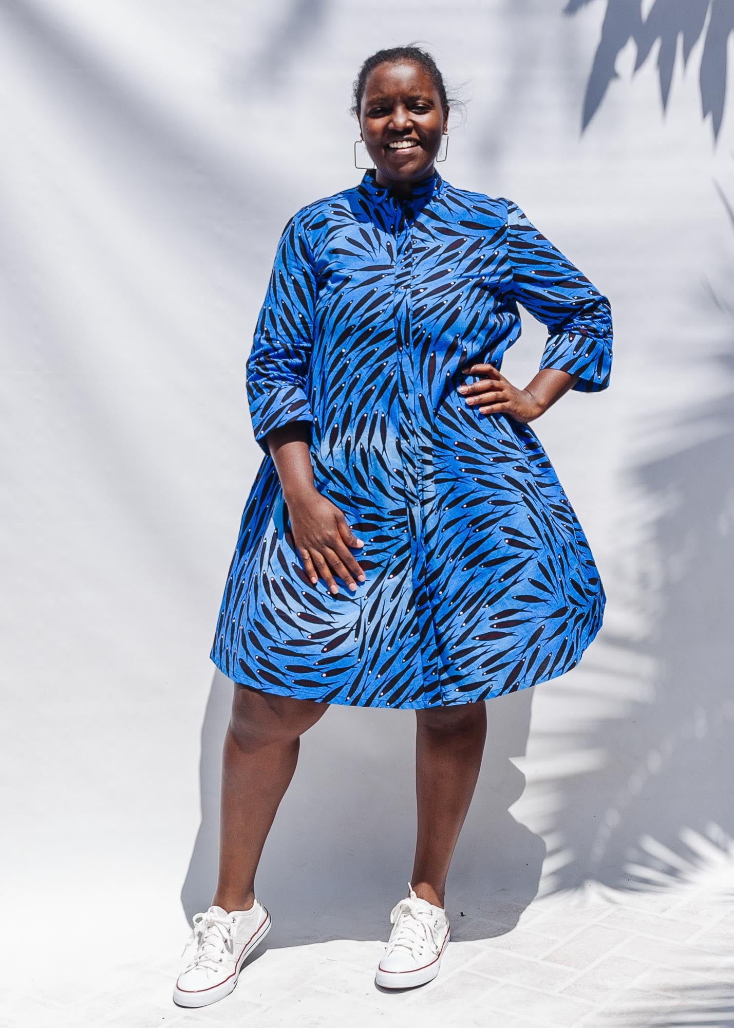 The model is wearing dark-red, blue and white baby shark printed dress