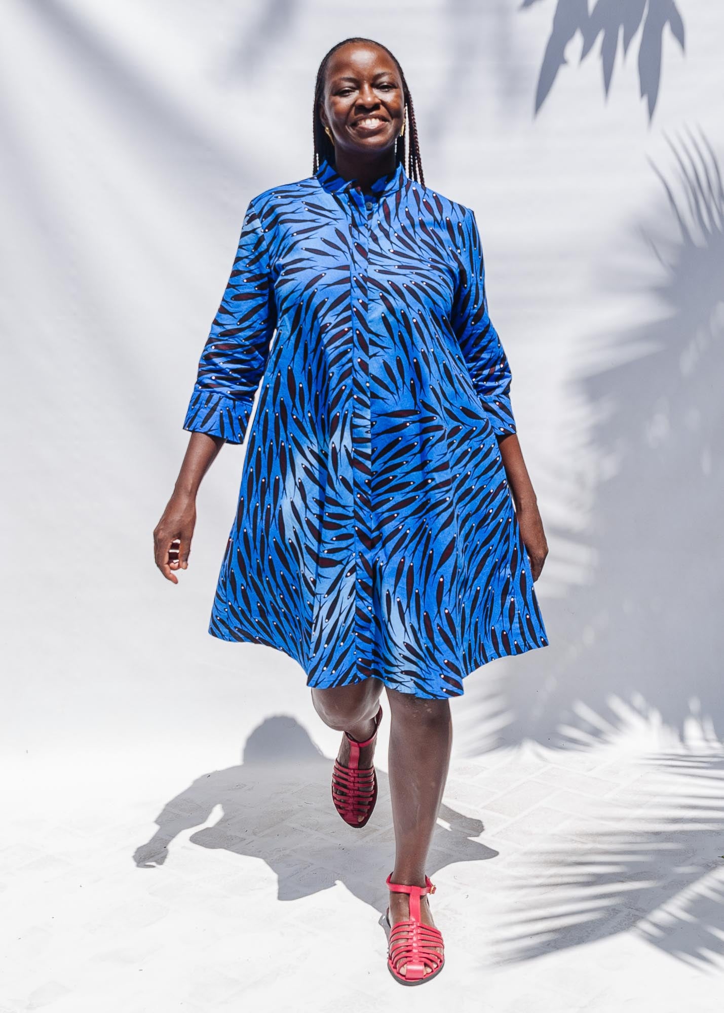 The model is wearing dark-red, blue and white baby shark printed dress