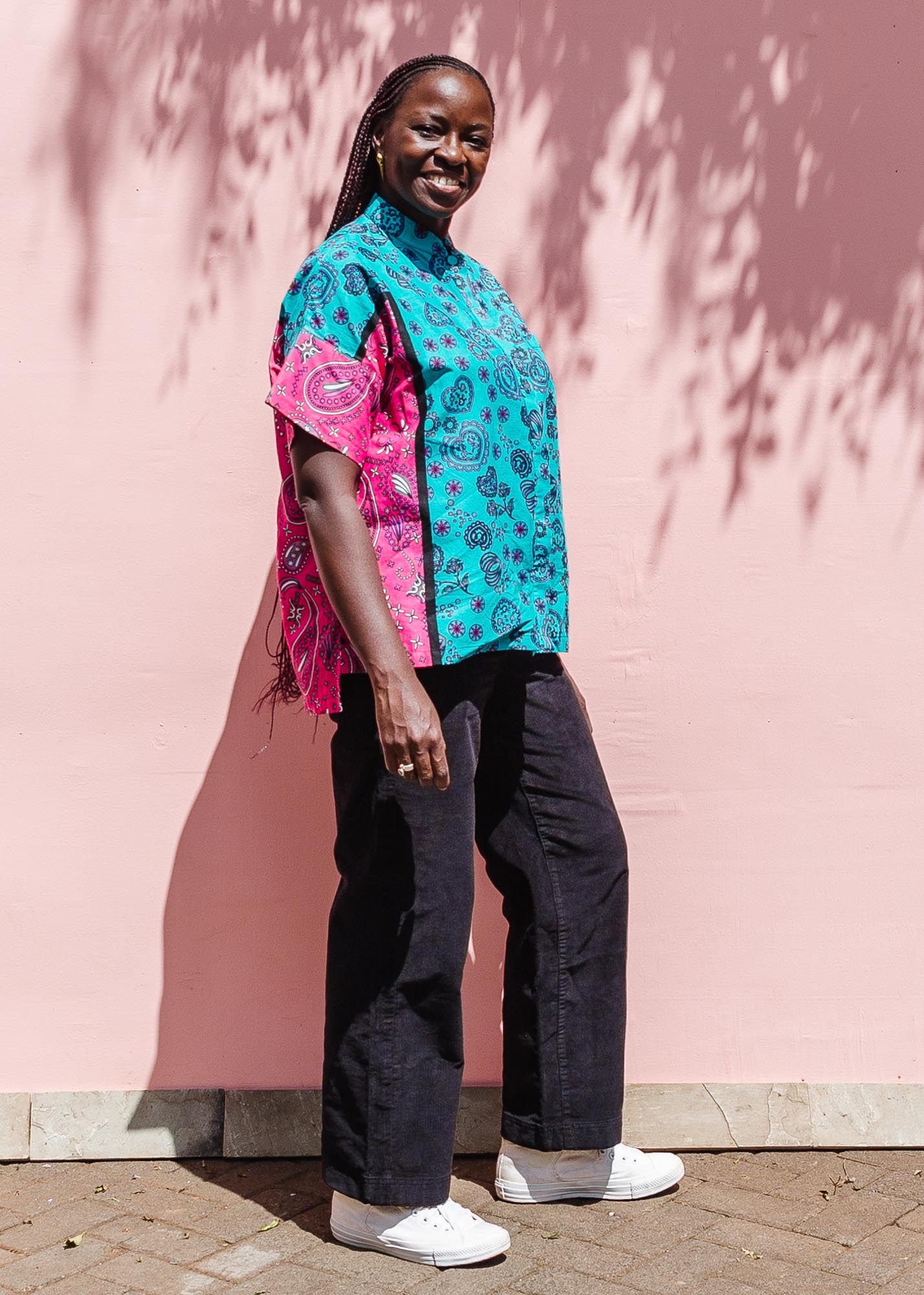 The model is wearing black, pink, sky blue, white, purple print shirt 