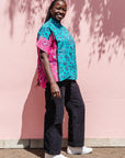 The model is wearing black, pink, sky blue, white, purple print shirt 