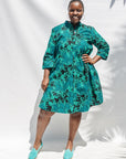  The model is wearing black, blue,  green print dress 