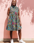  The model is wearing black, yellow, blue, red, pink print dress