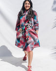 The model is wearing black, red, pink, light blue print dress