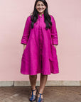 The model is wearing fuchsia dress