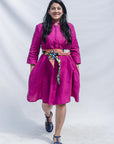 The model is wearing fuchsia dress