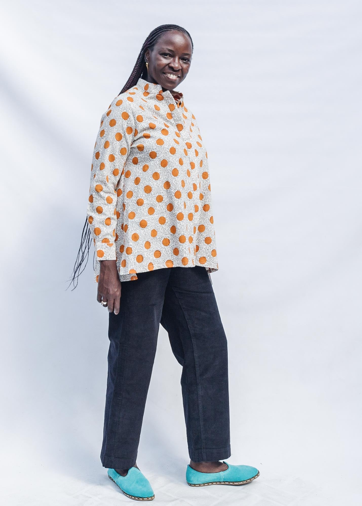 The model is wearing white, orange, brown shirt