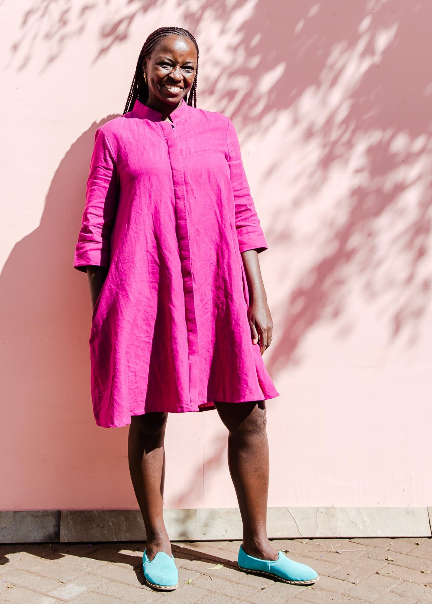 The model is wearing fuchsia dress