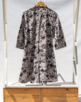 Display of black, off white, gray and dark gray abstract print dress