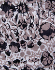 Close up display of black, off white, gray and dark gray abstract print dress