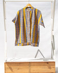 Display of olive-yellow, blue, orange and white geometric printed shirt