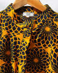 Display of black, yellow print dress