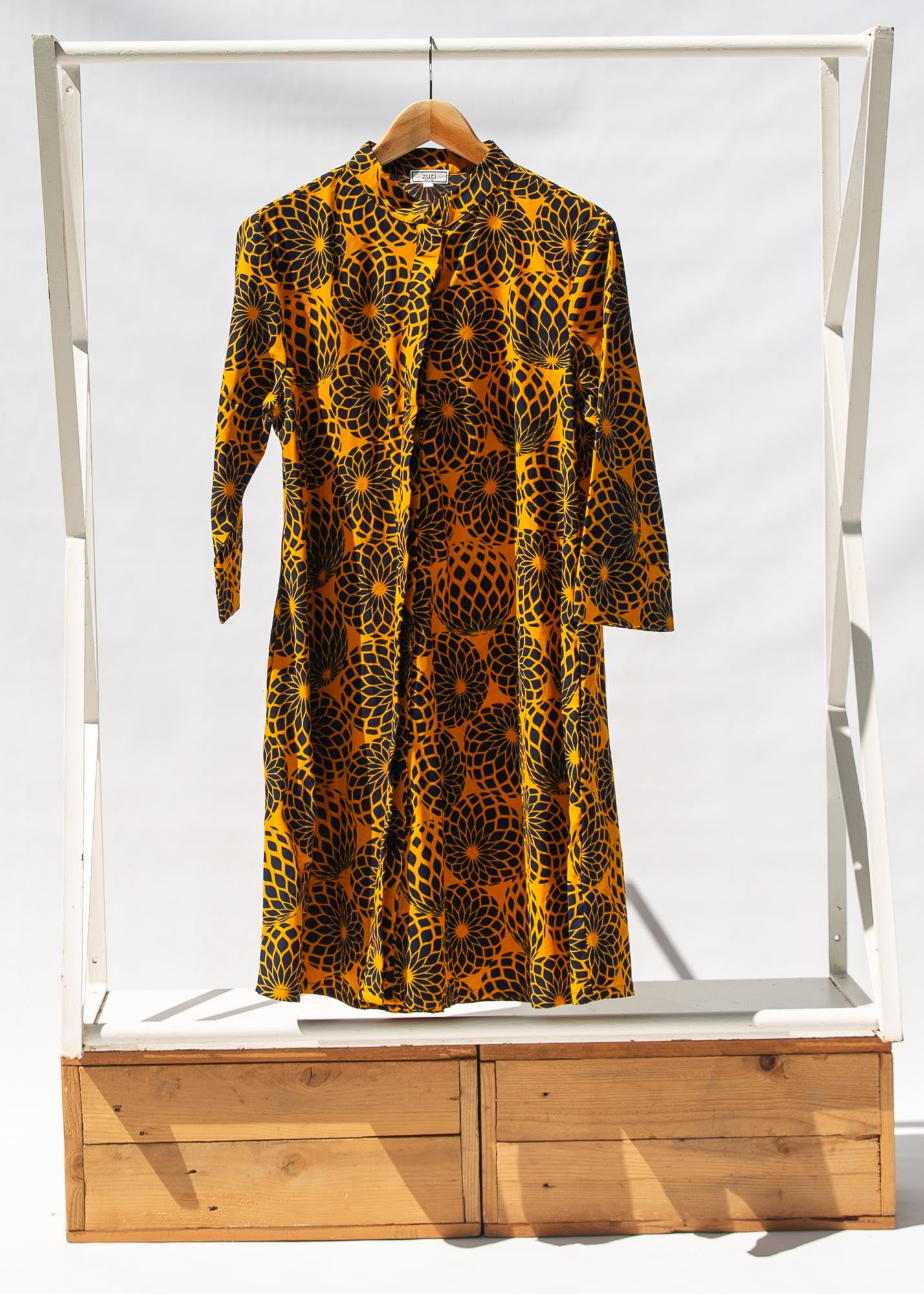 Display of black, yellow print dress