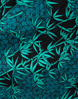 Close up display of black, blue, green print dress