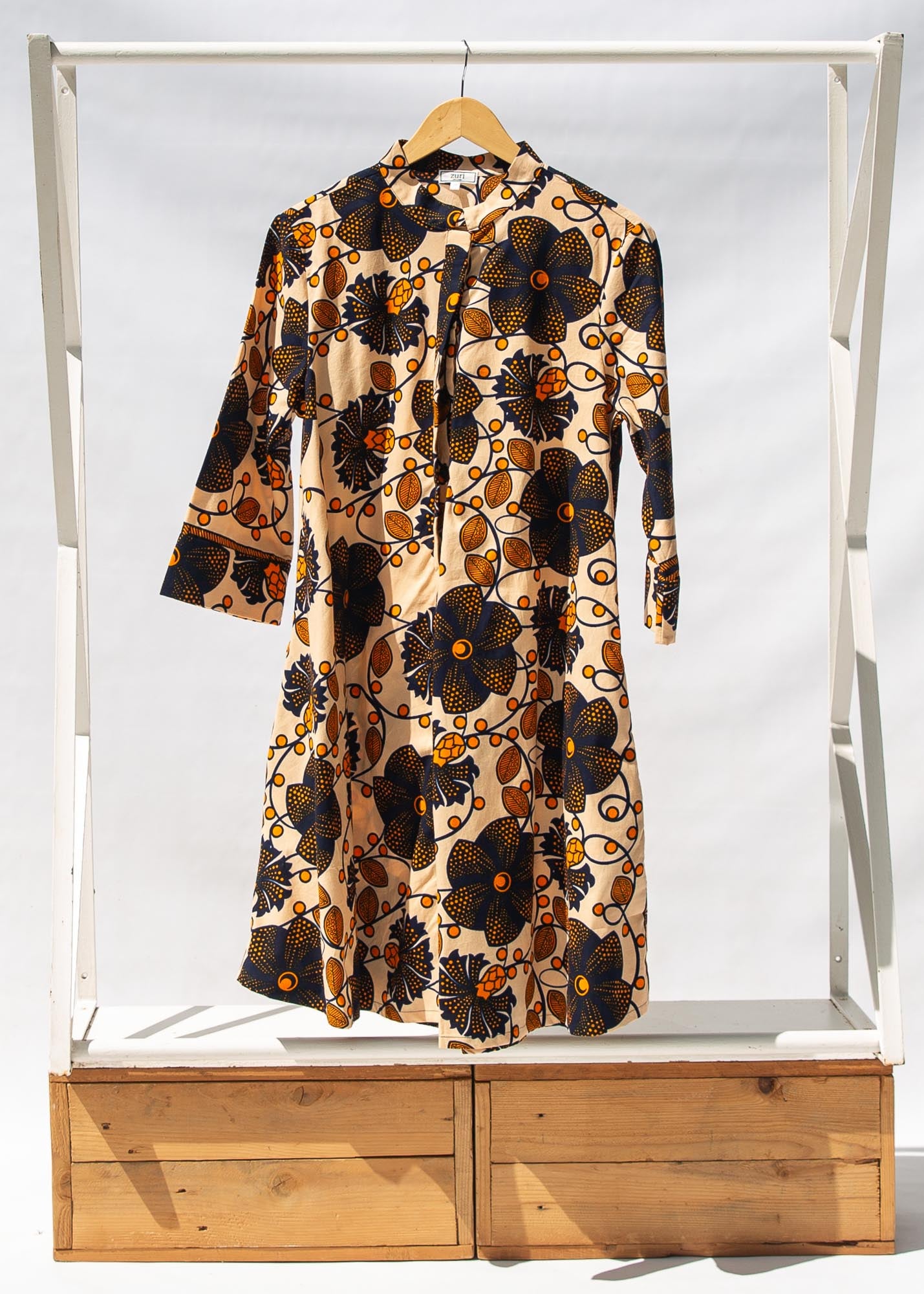 Display of navy, black, off white, yellow flower print dress 