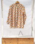 Display of white, orange, brown shirt