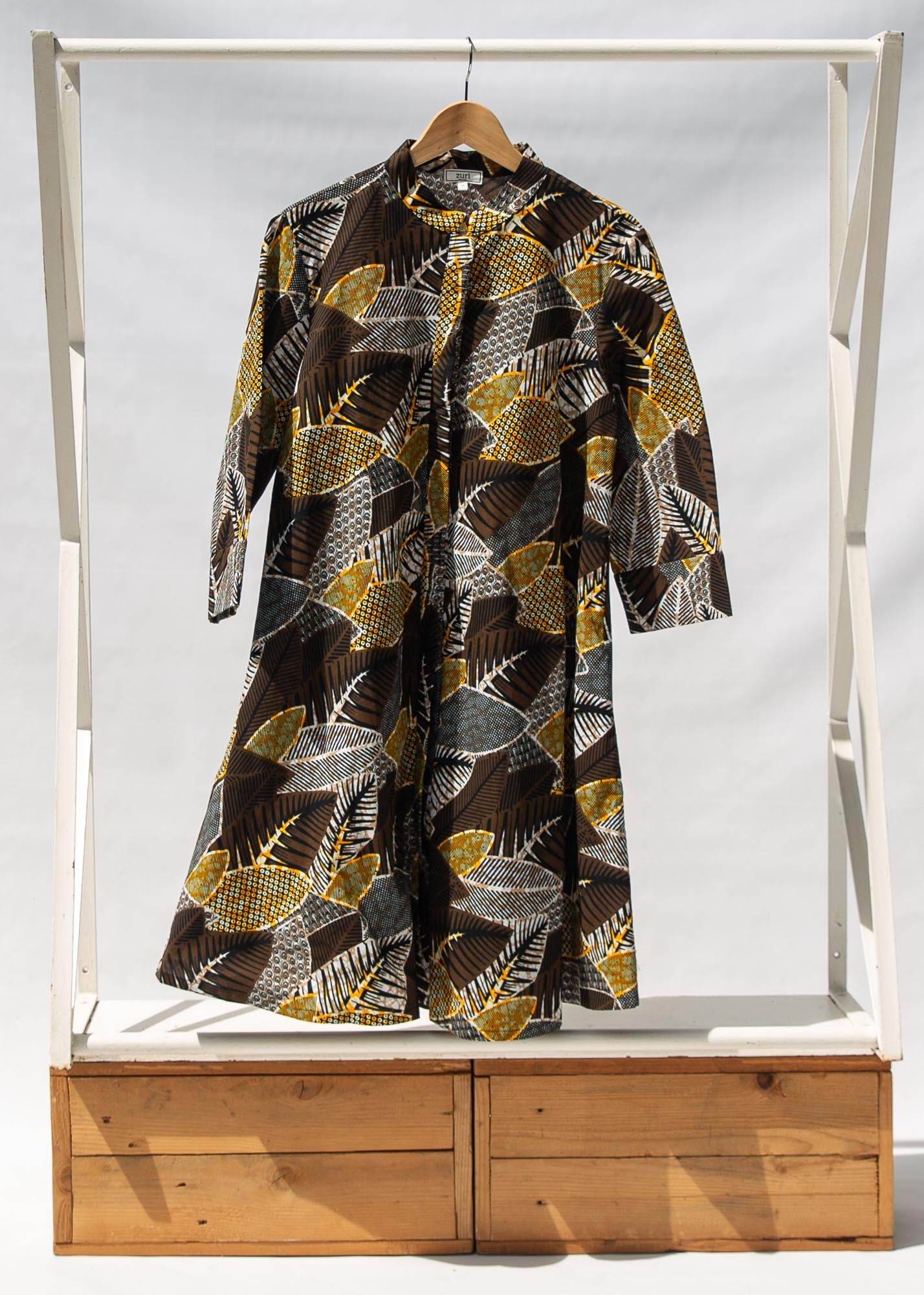 Display of black, brown, yellow, beige print dress 