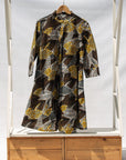 Display of black, brown, yellow, beige print dress 