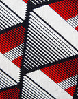 Close up display of black, red, off white print dress