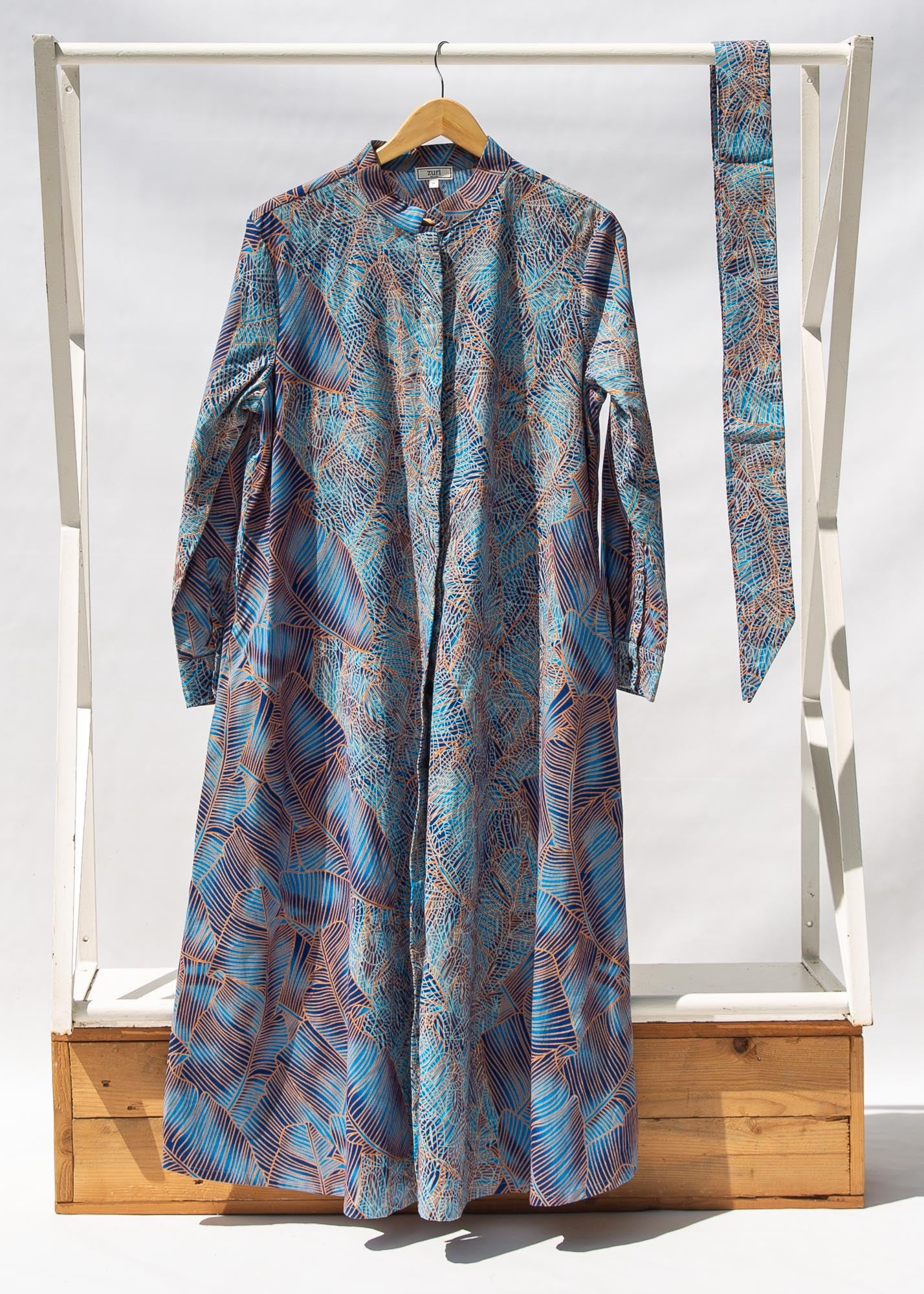 Display of sky blue, blue, orange print midi dress