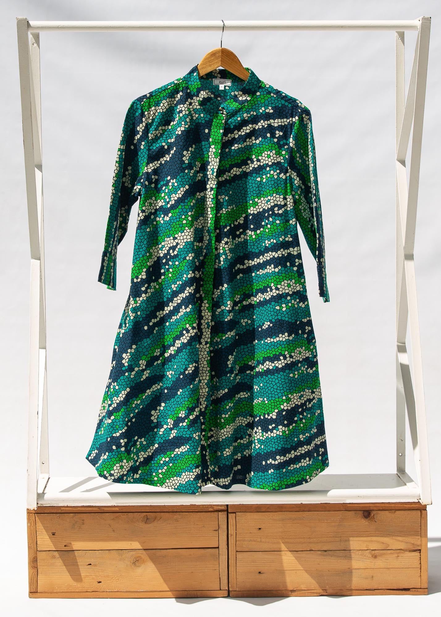 Display of black, green, white, blue and aqua print dress