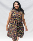 The model is wearing multi-colored abstract print dress