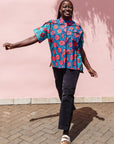 The model is wearing blue, pink, turquoise, black and white mixed pattern floral print shirt