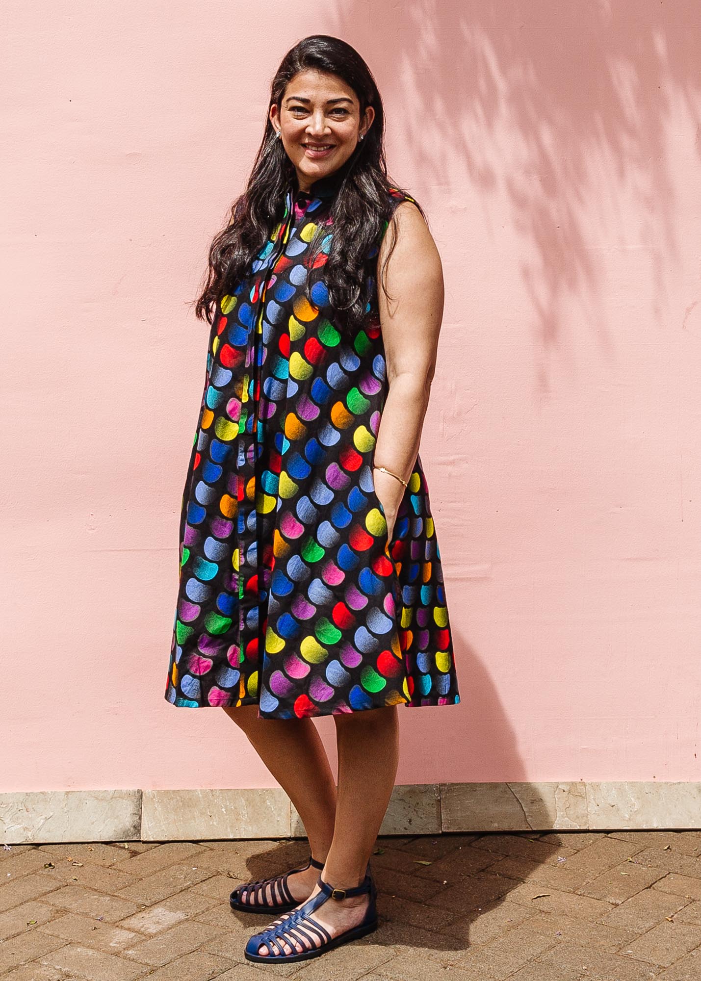 The model is wearing black dress with colorful panel