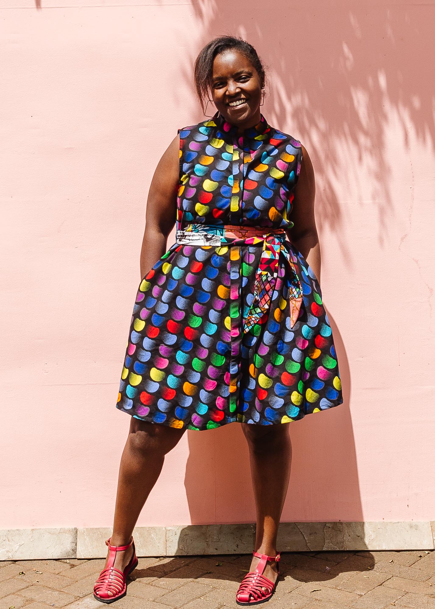 The model is wearing black dress with colorful panel