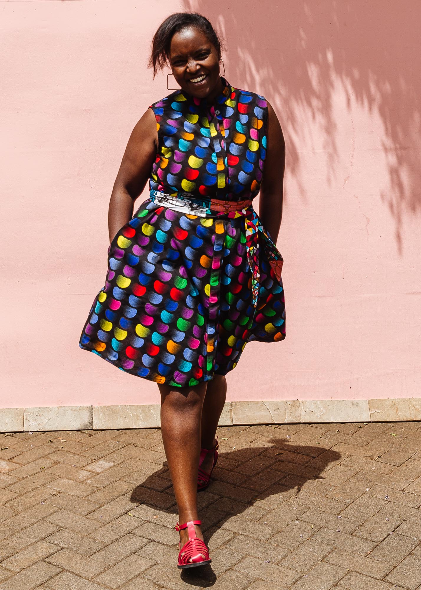 The model is wearing black dress with colorful panel