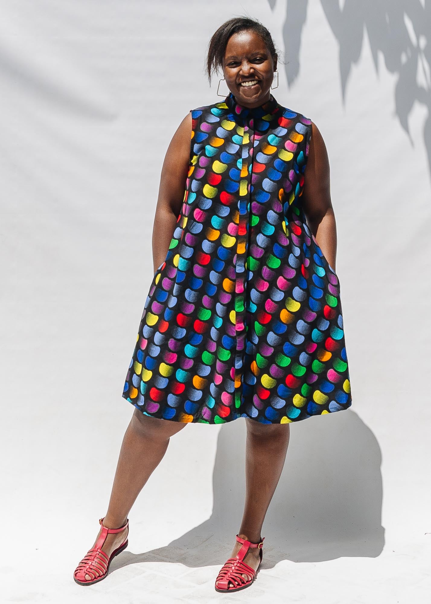 The model is wearing black dress with colorful panel