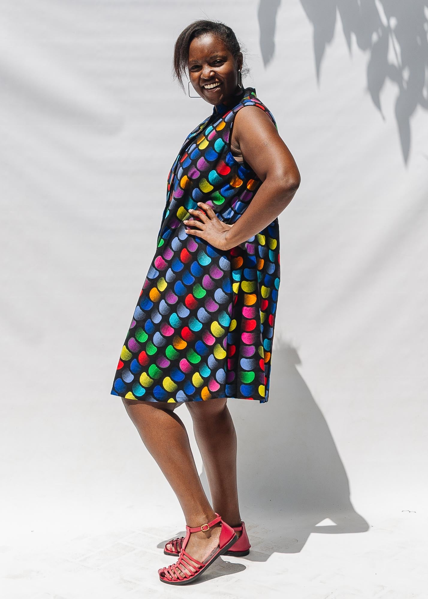 The model is wearing black dress with colorful panel