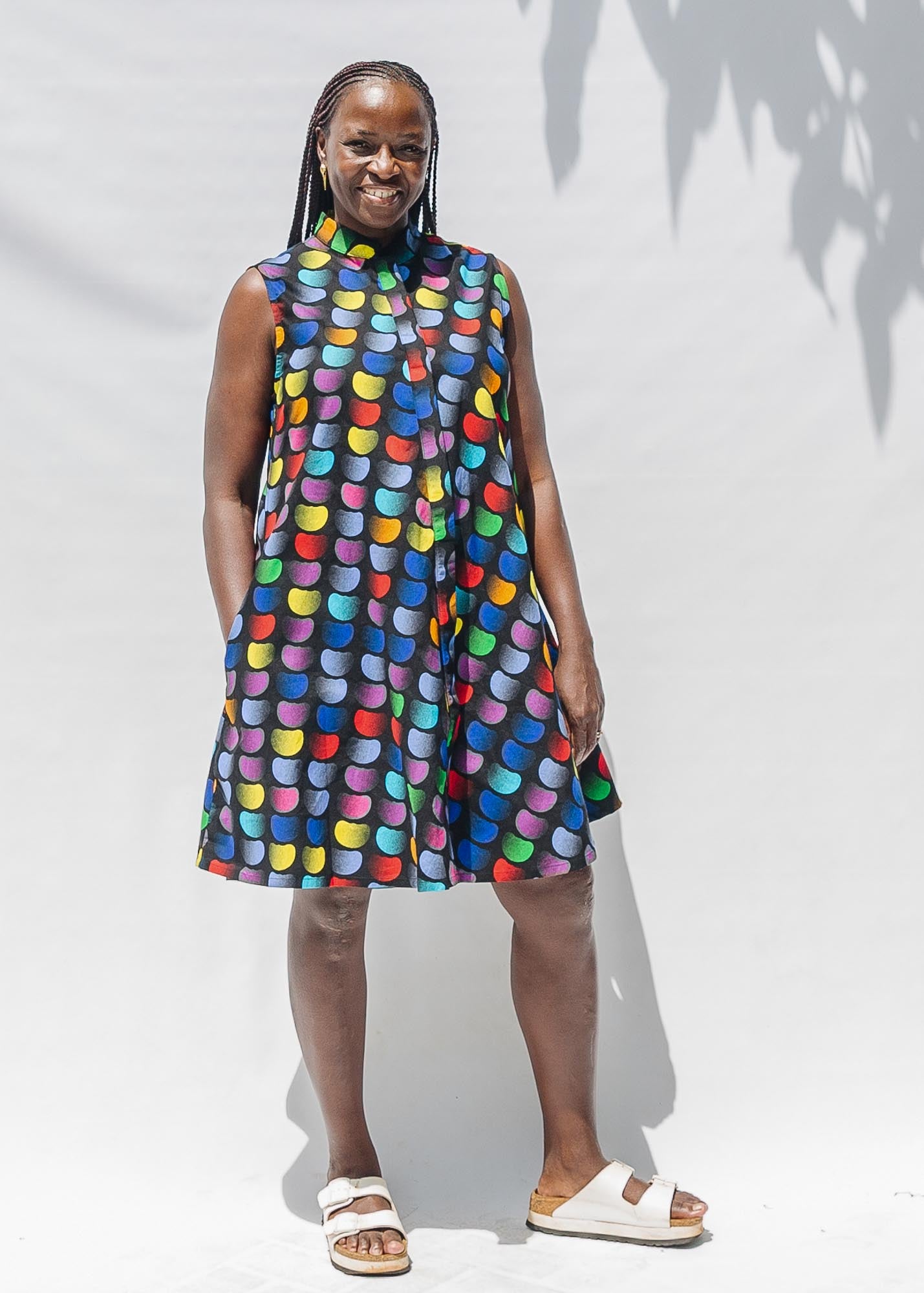 The model is wearing black dress with colorful panel