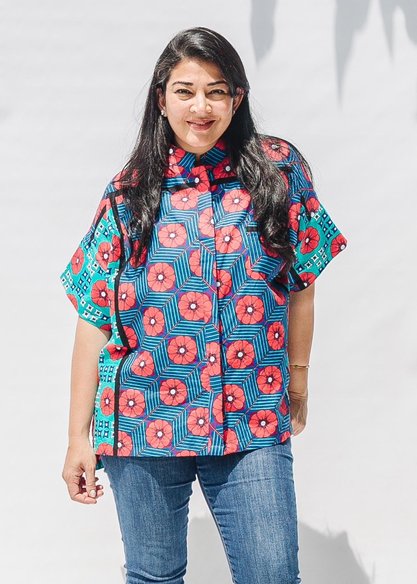 The model is wearing blue, pink, turquoise, black and white mixed pattern floral print shirt