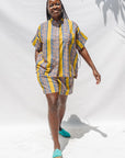 The model is wearing olive-yellow, blue, orange and white geometric printed shirt